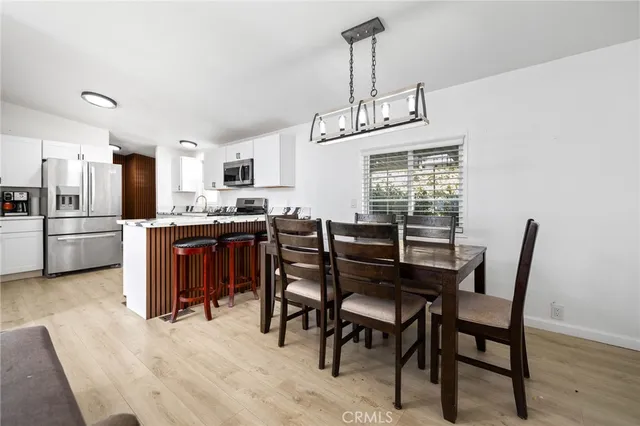 a kitchen with stainless steel appliances a stove a sink a microwave a refrigerator and cabinets