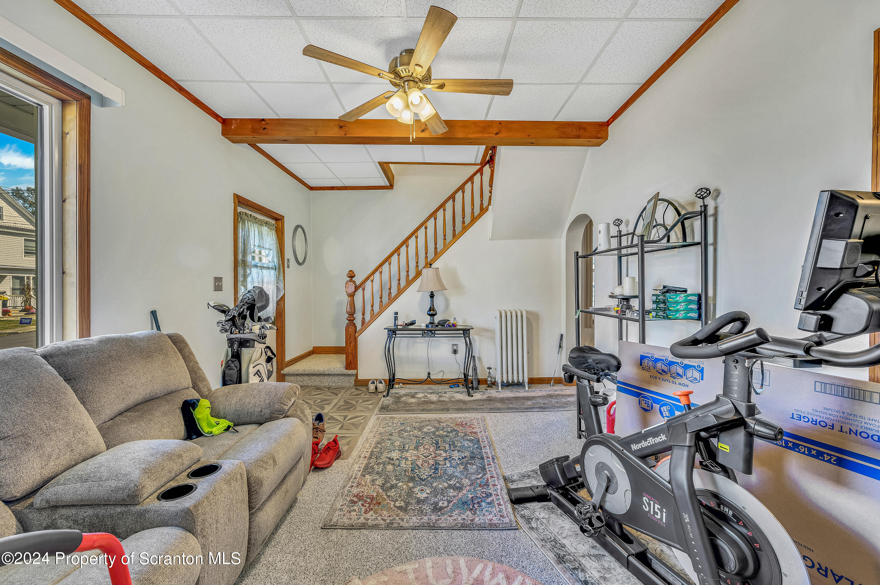 112 East Taylor Street Taylor, PA 18517 - Photo 13 of 45 a living room with lots of furniture and gym equipment