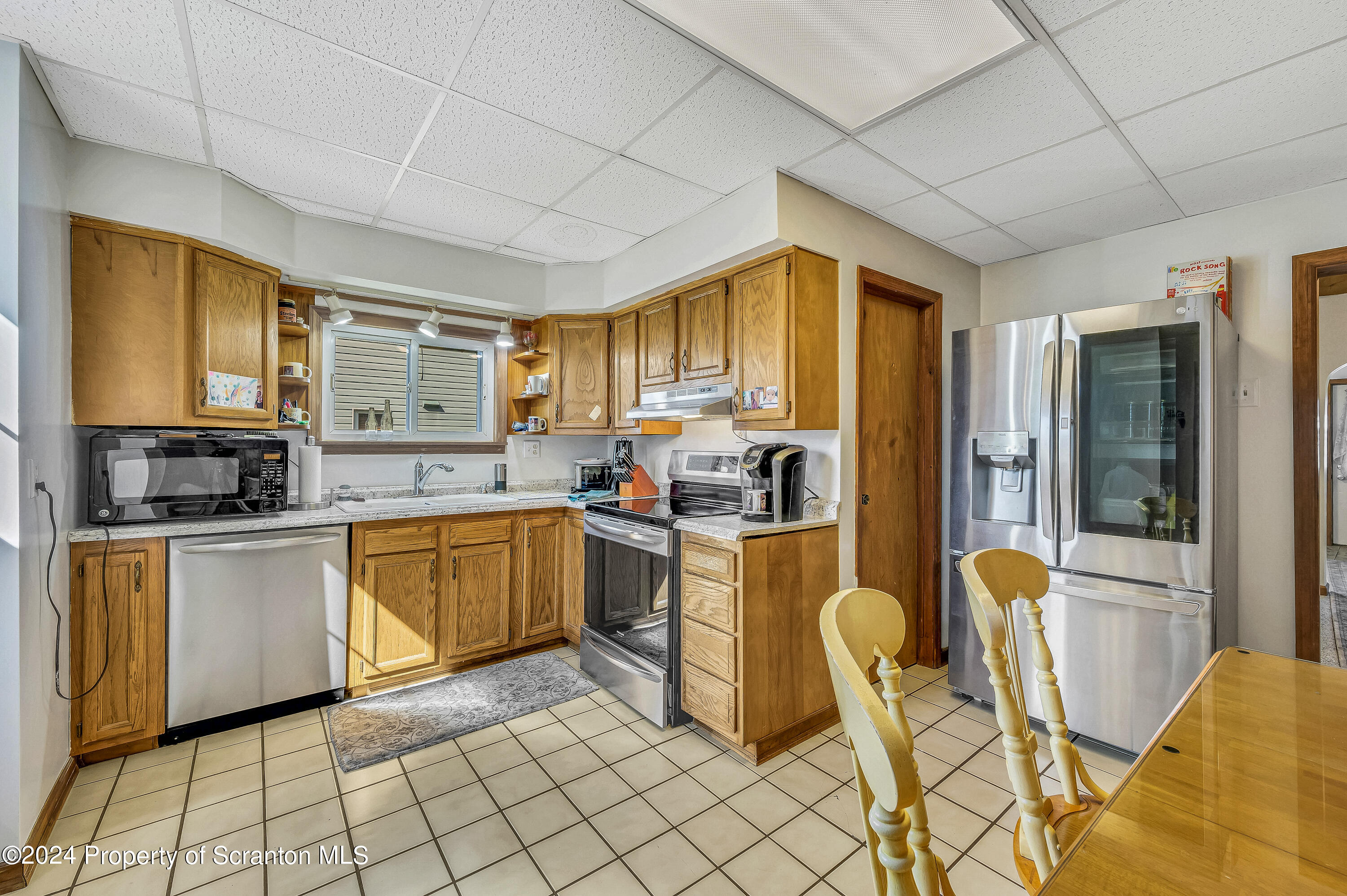 112 East Taylor Street Taylor, PA 18517 - Photo 21 of 45 a kitchen with cabinets and chairs