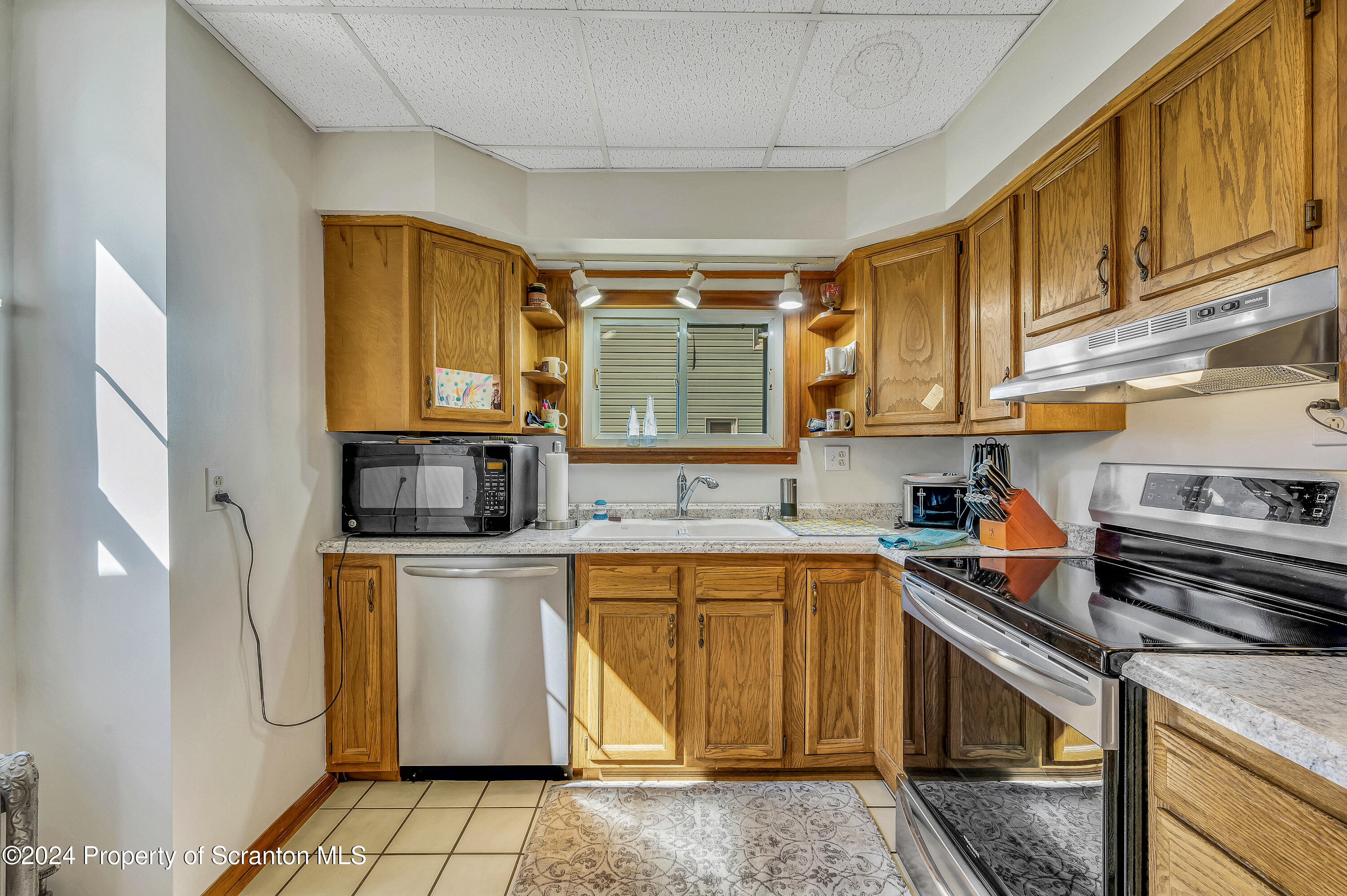 112 East Taylor Street Taylor, PA 18517 - Photo 22 of 45 a kitchen with stainless steel appliances granite countertop a sink a stove and cabinets