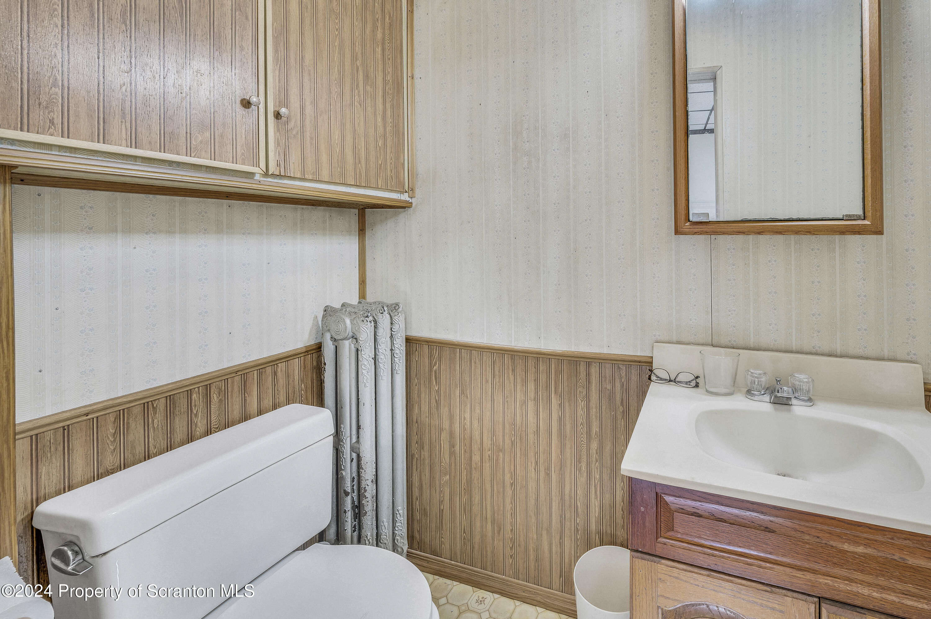 112 East Taylor Street Taylor, PA 18517 - Photo 33 of 45 a bathroom with a sink a toilet and mirror