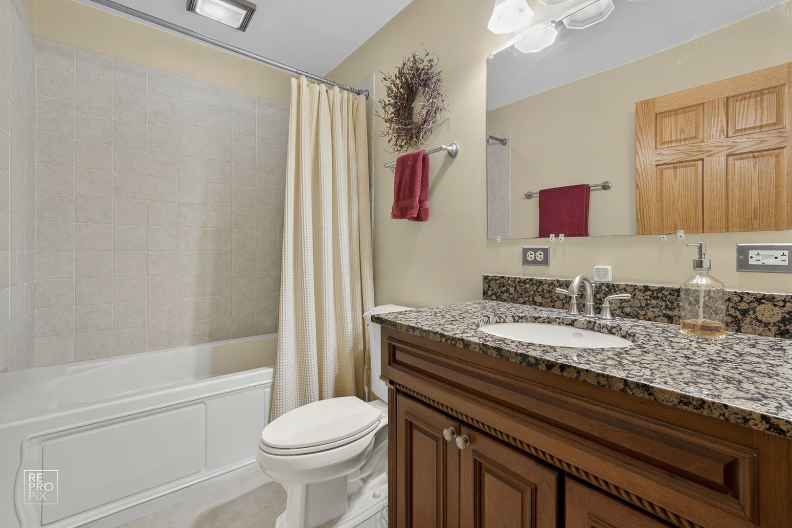 828 Carlisle Road Batavia, IL 60510 - Photo 11 of 14 a bathroom with a granite countertop toilet sink and mirror