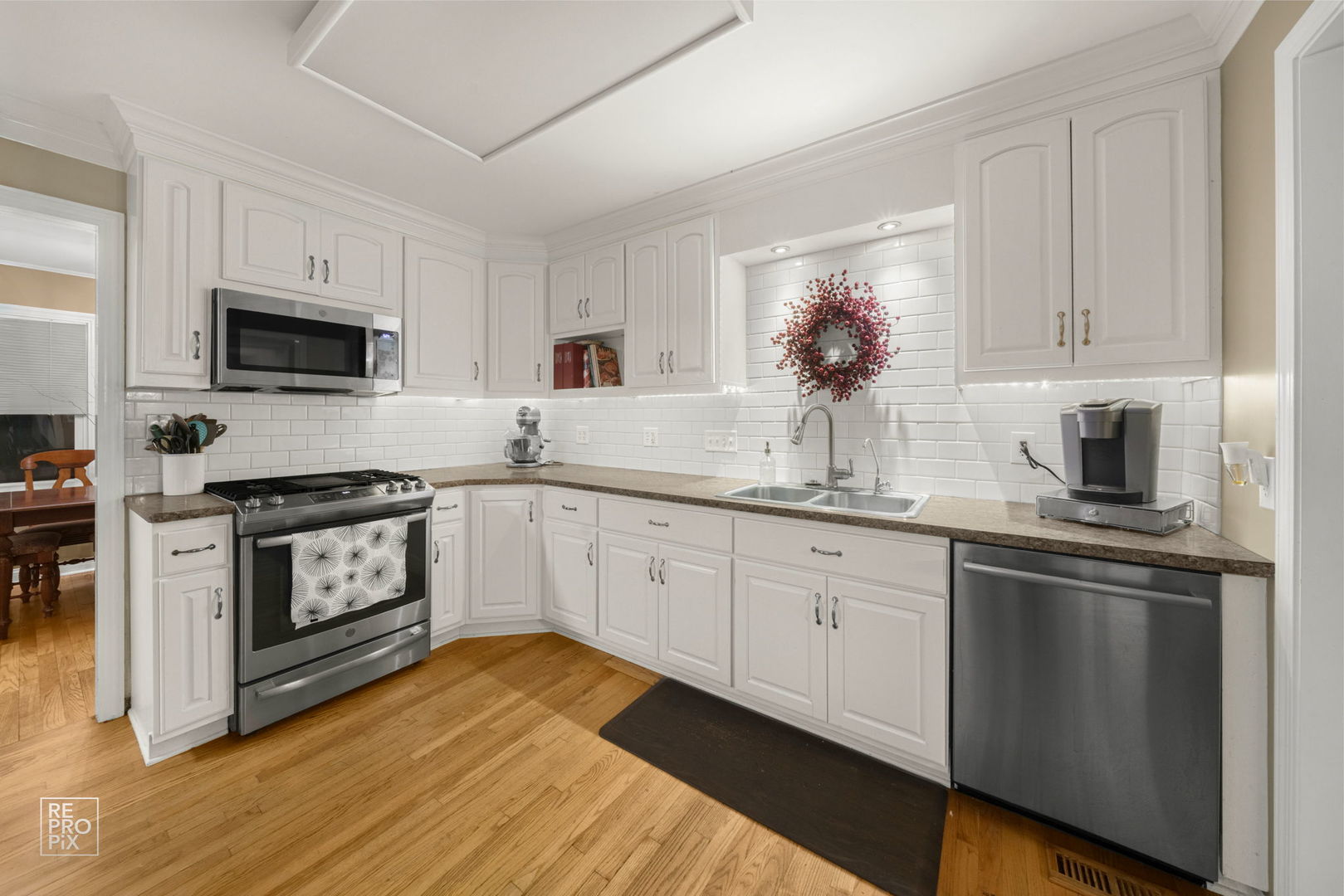 828 Carlisle Road Batavia, IL 60510 - Photo 6 of 14 a kitchen with granite countertop white cabinets stainless steel appliances a sink and dishwasher