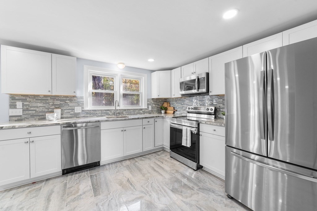 22 Leonard Road Sharon, MA 02067 - Photo 11 of 41 a kitchen with granite countertop a refrigerator stove top oven and sink