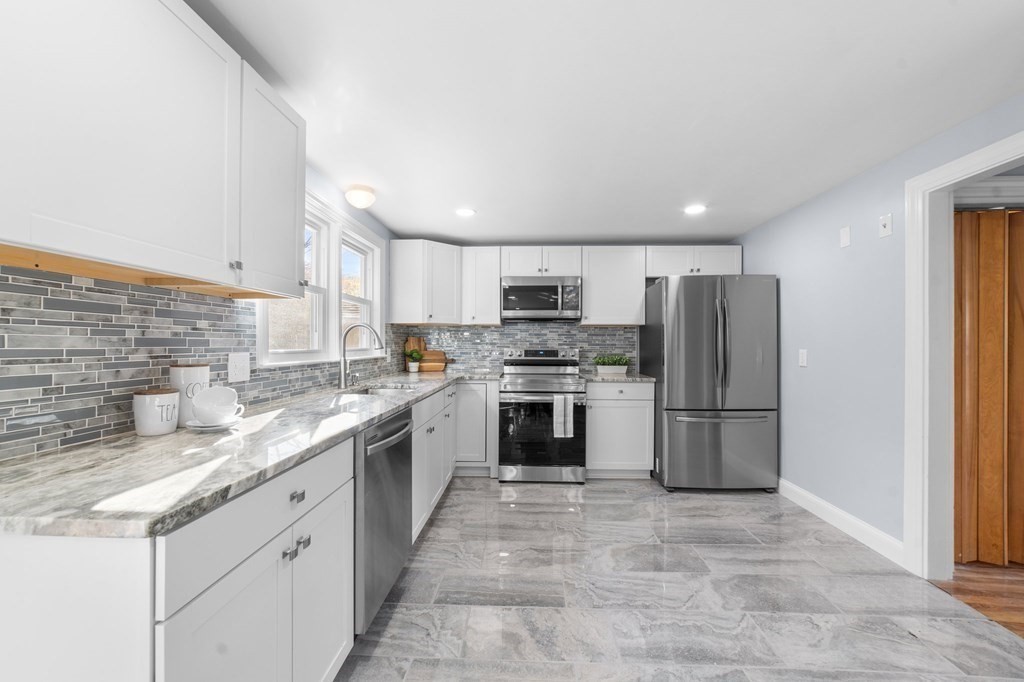 22 Leonard Road Sharon, MA 02067 - Photo 12 of 41 a kitchen with a sink a refrigerator and a oven