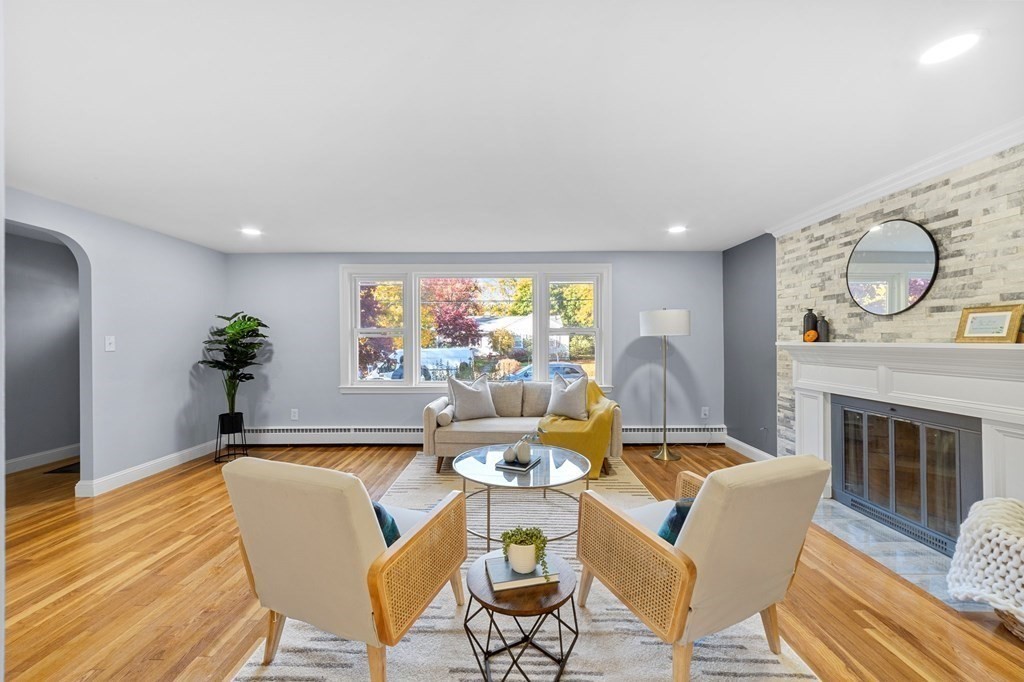 22 Leonard Road Sharon, MA 02067 - Photo 2 of 41 a dining room with furniture a fireplace and wooden floor