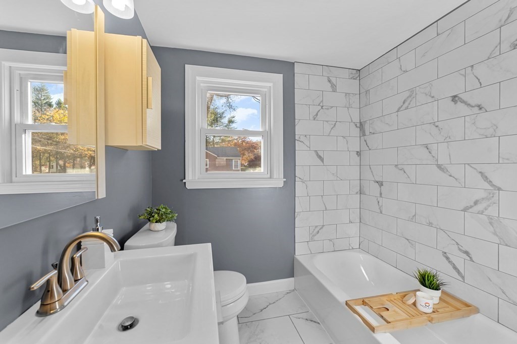 22 Leonard Road Sharon, MA 02067 - Photo 28 of 41 a bath tub sitting next to a white sink and a window