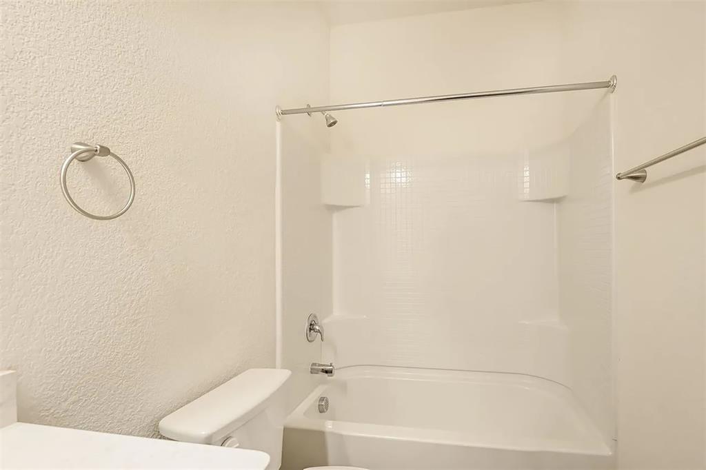 6214 Old Bridge Way Forney, TX 75126 - Photo 10 of 15 a bathroom with a bathtub and a shower