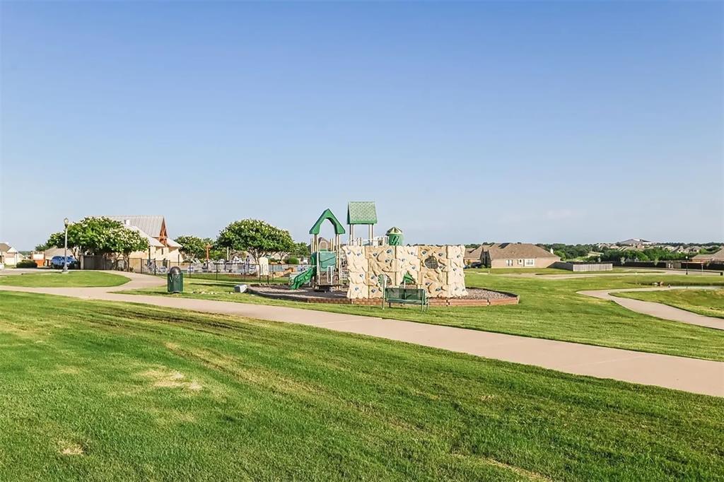 6214 Old Bridge Way Forney, TX 75126 - Photo 13 of 15 a view of a house with a big yard and a large trees