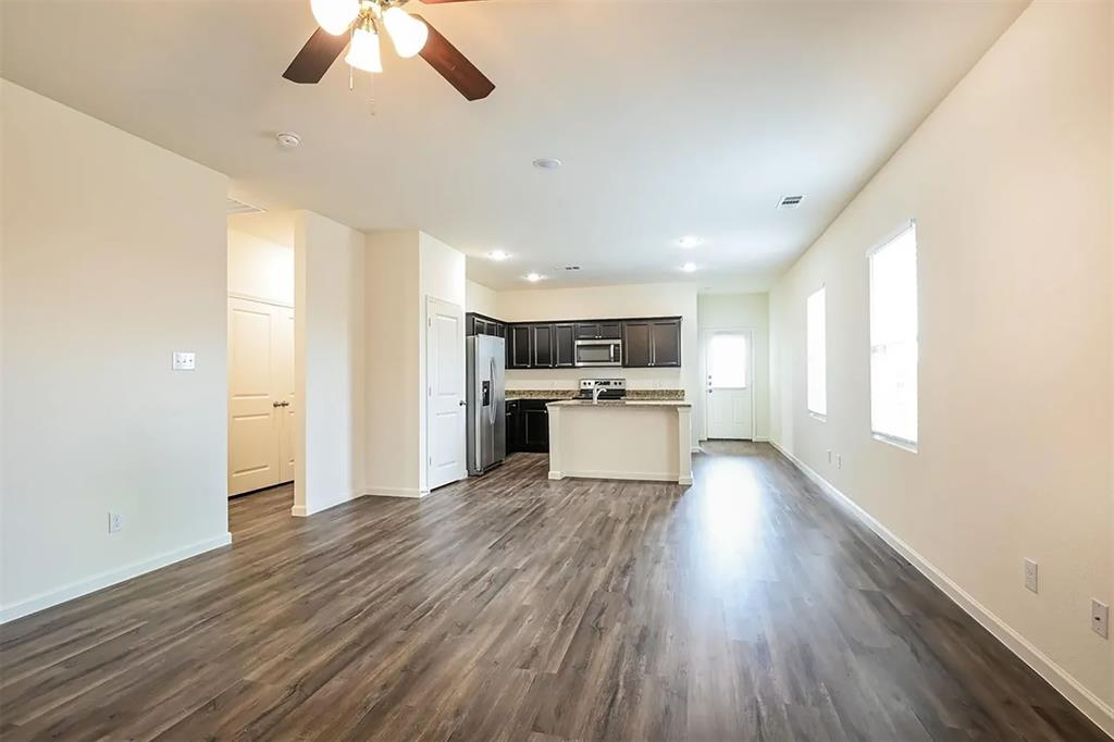 6214 Old Bridge Way Forney, TX 75126 - Photo 2 of 15 a view of kitchen with wooden floor electronic appliances and window