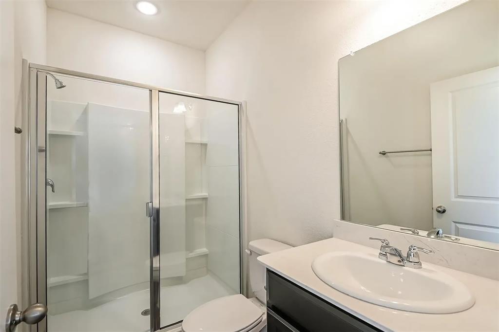 6214 Old Bridge Way Forney, TX 75126 - Photo 6 of 15 a bathroom with a sink toilet and shower