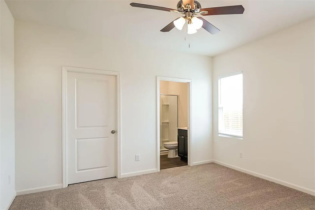 6214 Old Bridge Way Forney, TX 75126 - Photo 8 of 15 an empty room with closet and a chandelier fan