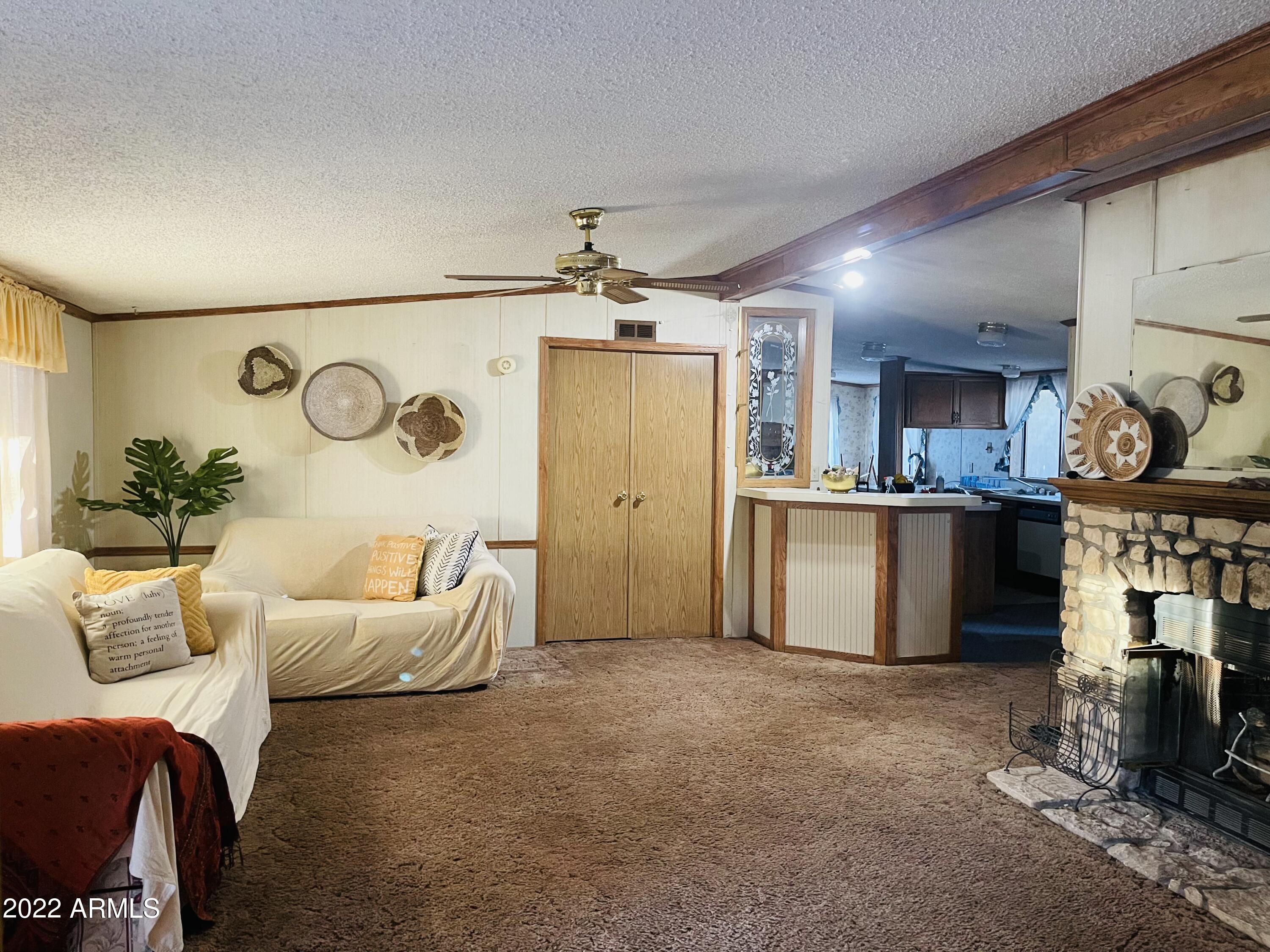 3325 North Buckskin Road Overgaard, AZ 85933 - Photo 6 of 26 a living room with furniture and kitchen view