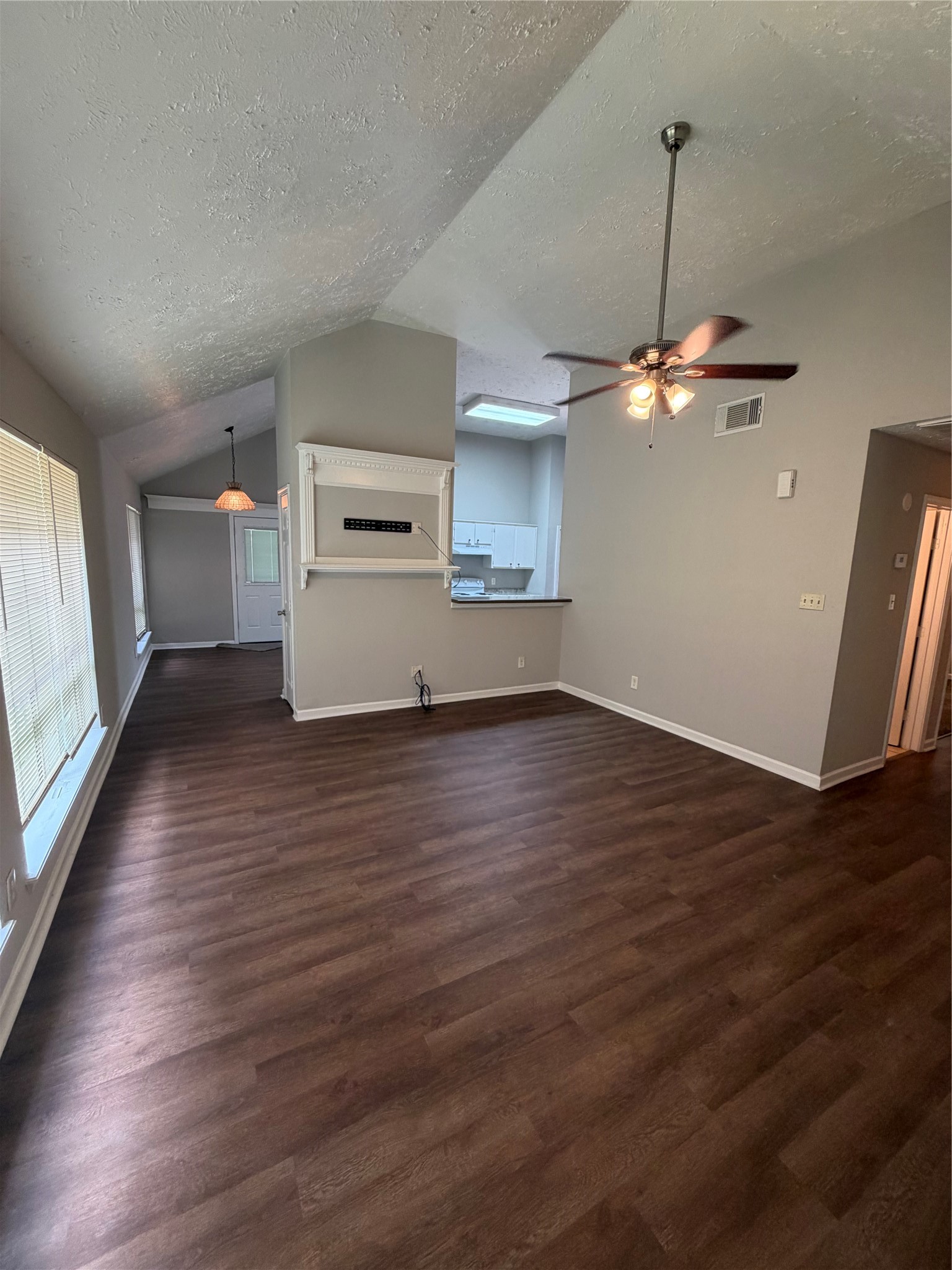 8662 Pearl Point Street Houston, TX 77044 - Photo 14 of 28 an empty room with wooden floor chandelier fan and windows
