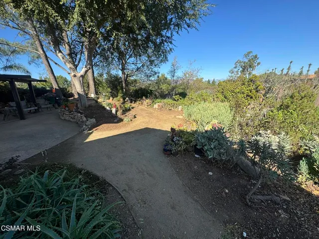 a view of a house with a tree and yard