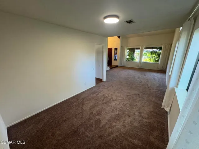 a view of hallway with a window and stairs