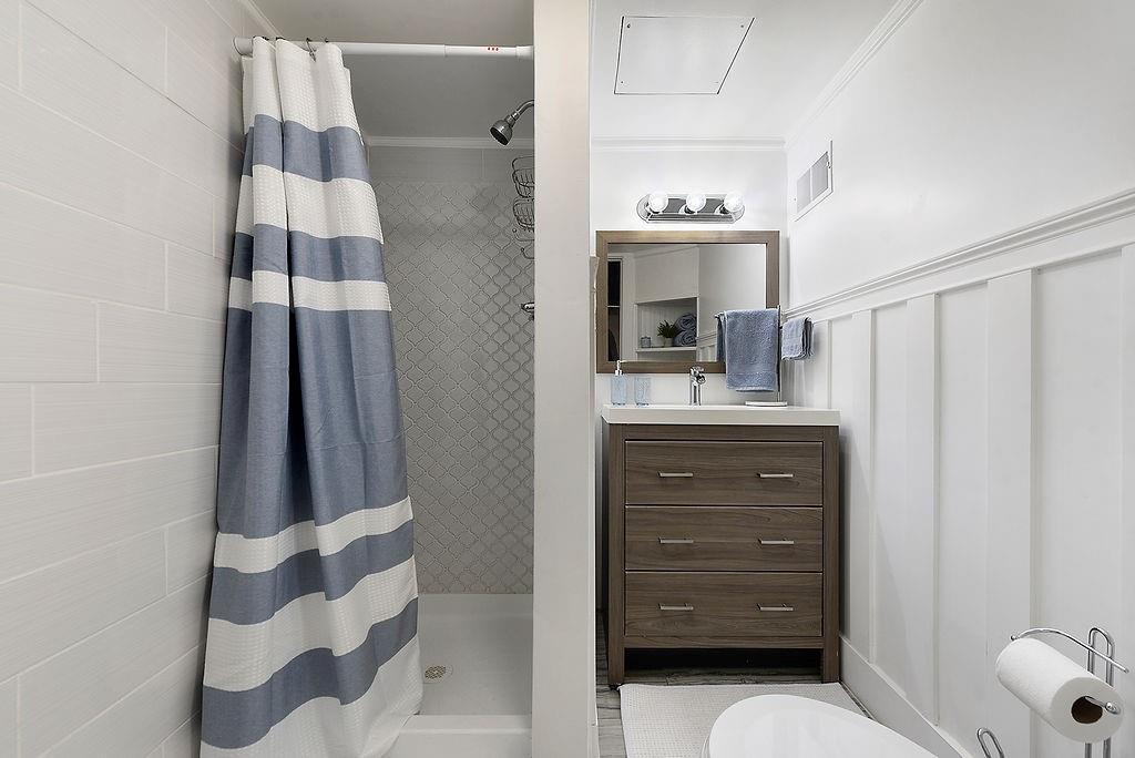 6906 Standish Street Pittsburgh, PA 15206 - Photo 29 of 31 a bathroom with a sink and a mirror