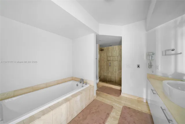 a spacious bathroom with a bathtub and shower