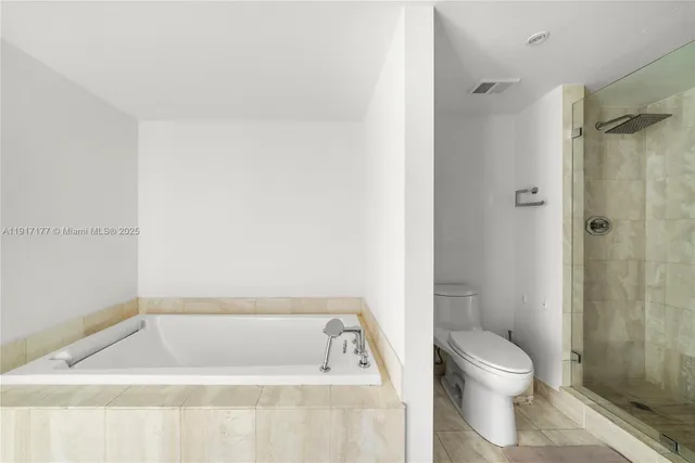 a bathroom with a bathtub and toilet