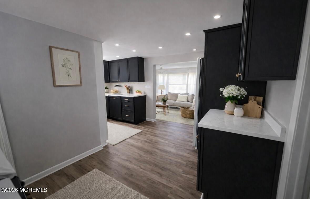 17 North Main Street Marlboro, NJ 07746 - Photo 15 of 67 a kitchen with stainless steel appliances granite countertop a refrigerator a sink dishwasher and a dining table with wooden floor