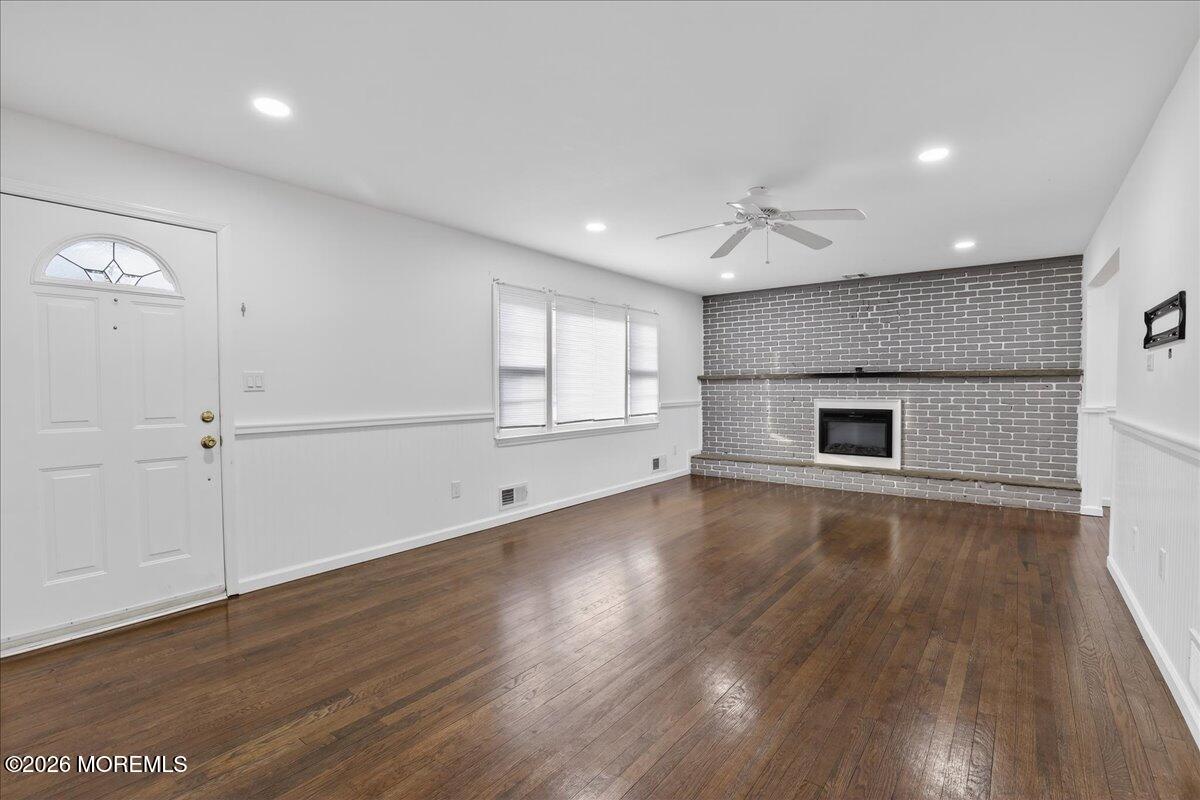17 North Main Street Marlboro, NJ 07746 - Photo 32 of 67 an empty room with wooden floor cabinet and windows