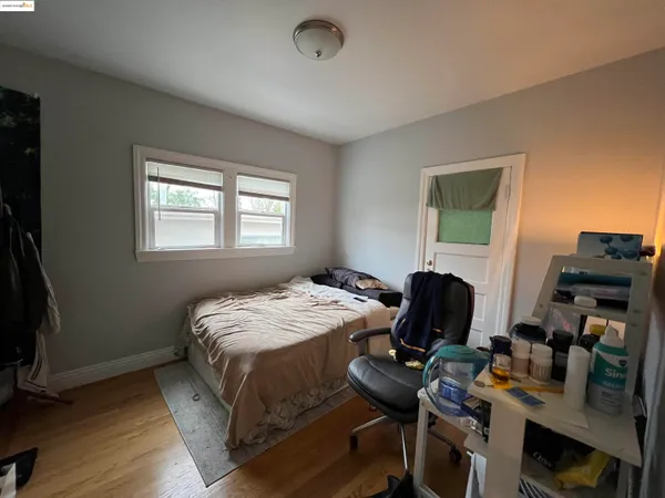 a bedroom with bed chair and a window