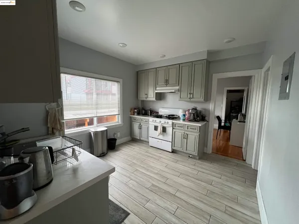 a kitchen with a sink appliances cabinets and a window