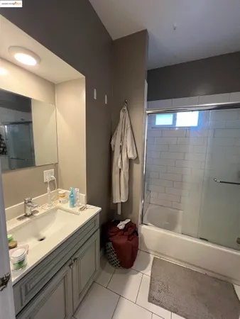 a bathroom with a double vanity sink mirror and shower