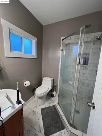 a bathroom with a toilet and a shower