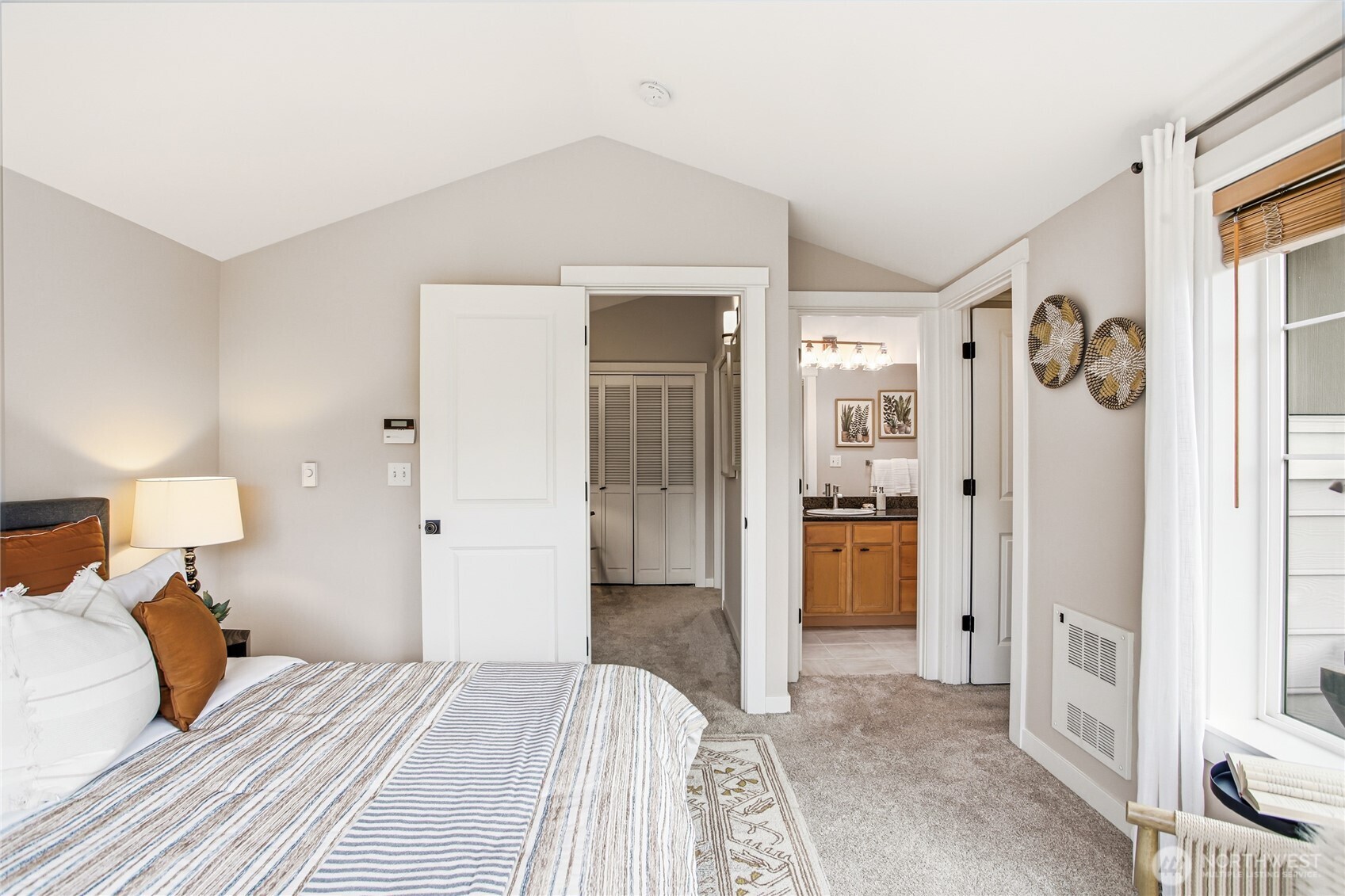 2635 Northwest 57th Street, Unit B Seattle, WA 98107 - Photo 13 of 28 a bedroom with a bed and a refrigerator