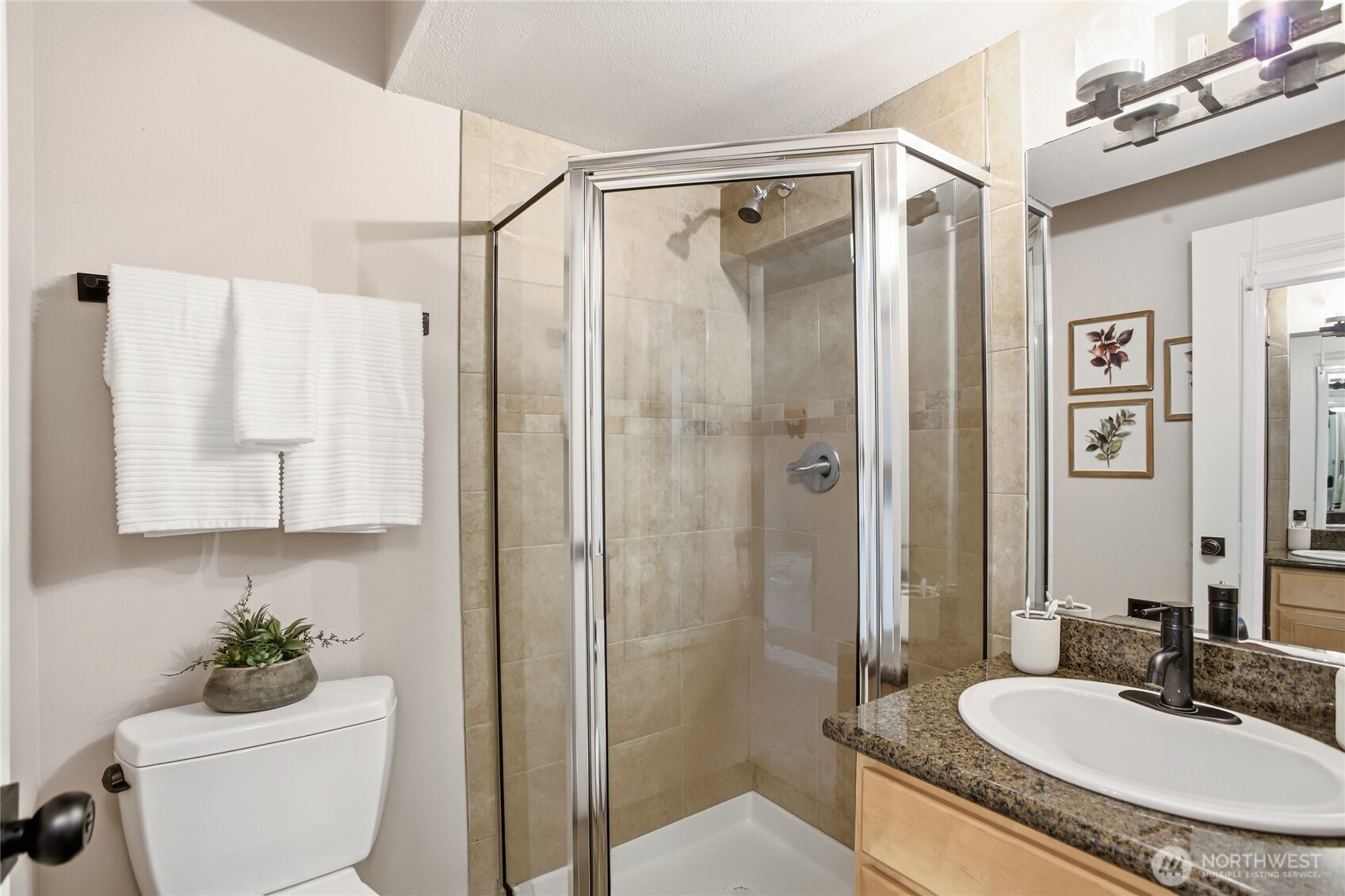 2635 Northwest 57th Street, Unit B Seattle, WA 98107 - Photo 19 of 28 a bathroom with a granite countertop sink toilet and shower