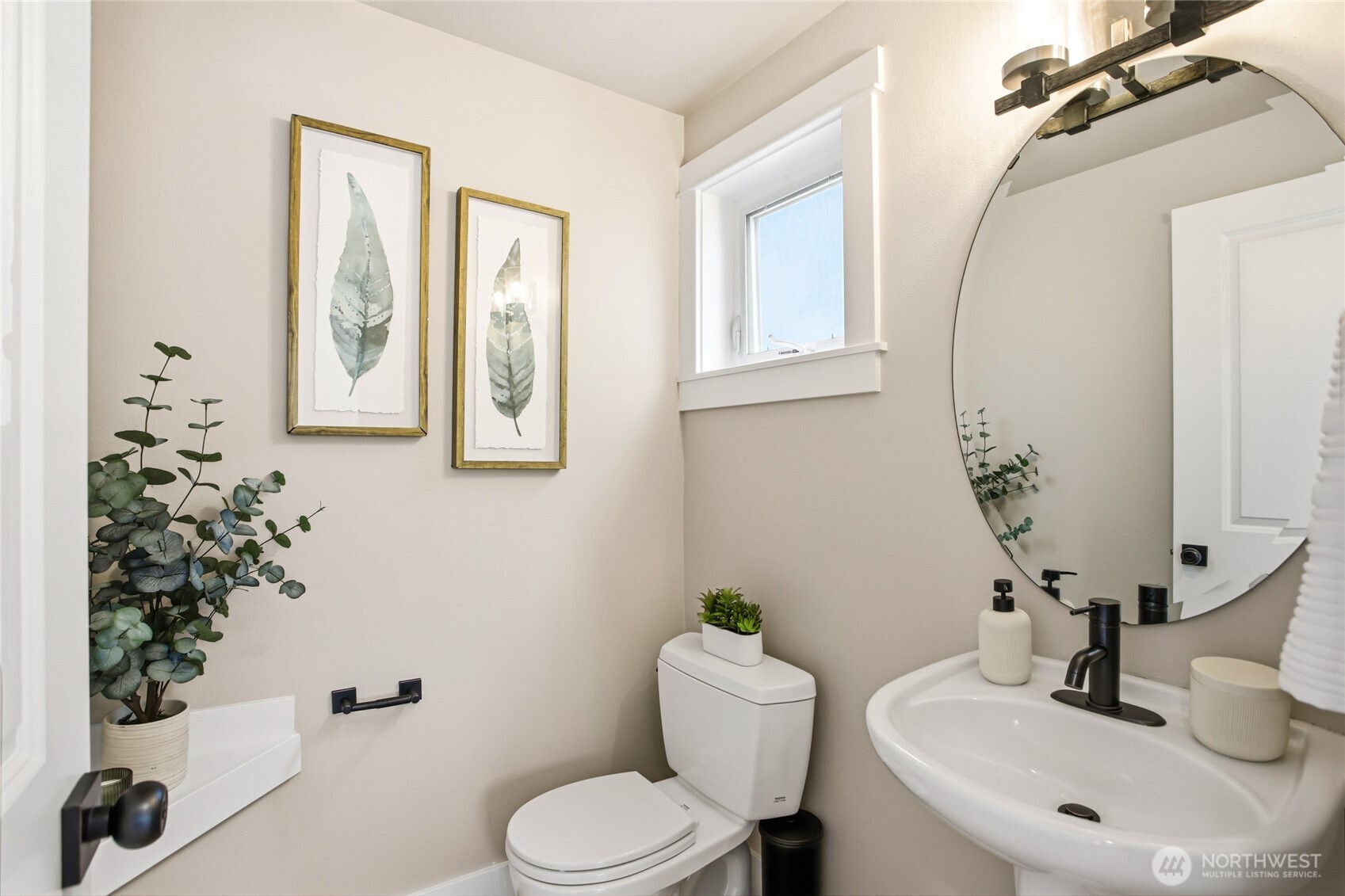 2635 Northwest 57th Street, Unit B Seattle, WA 98107 - Photo 22 of 28 a bathroom with a toilet sink and mirror