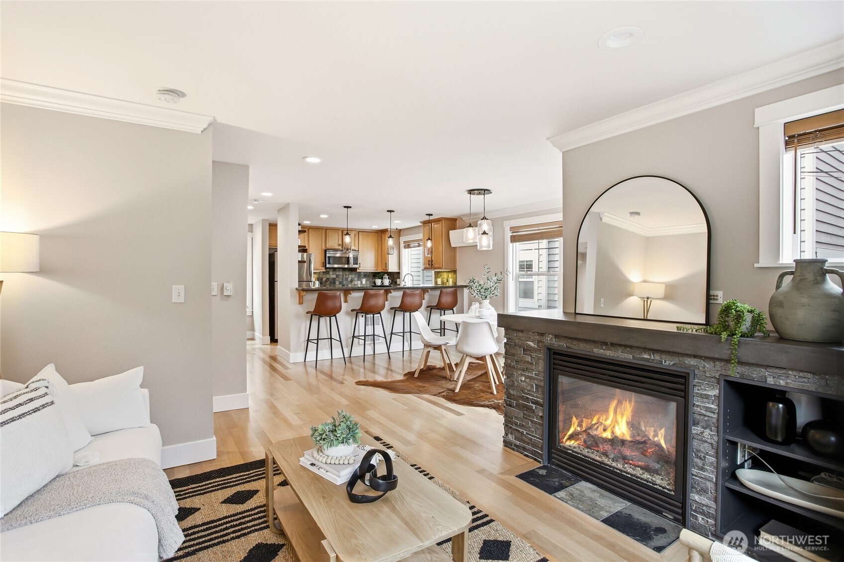 2635 Northwest 57th Street, Unit B Seattle, WA 98107 - Photo 5 of 28 a living room with furniture a fireplace and a floor to ceiling window