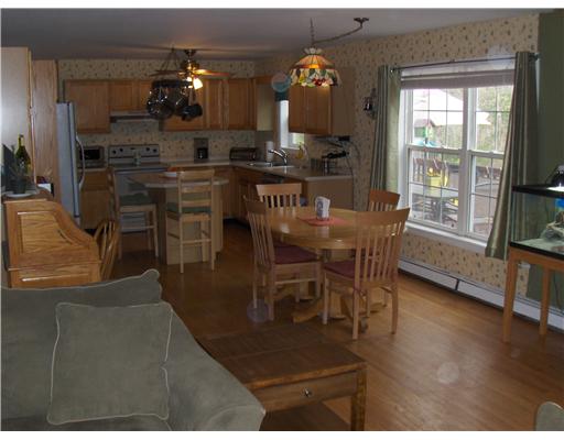 296 Sheffield Hill Road Exeter, RI 02822 - Photo 3 of 10 Kitchen. Spacious...open country kitchen.....breakfast bar, and dining area..hardwood flooring throughout the main living level....ties nicely into the fireplaced family room.....