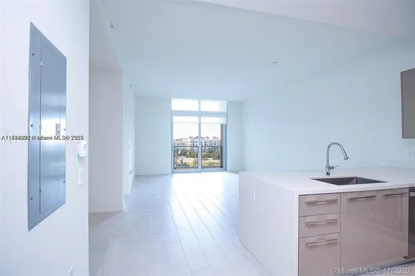 a kitchen with a sink and chandelier