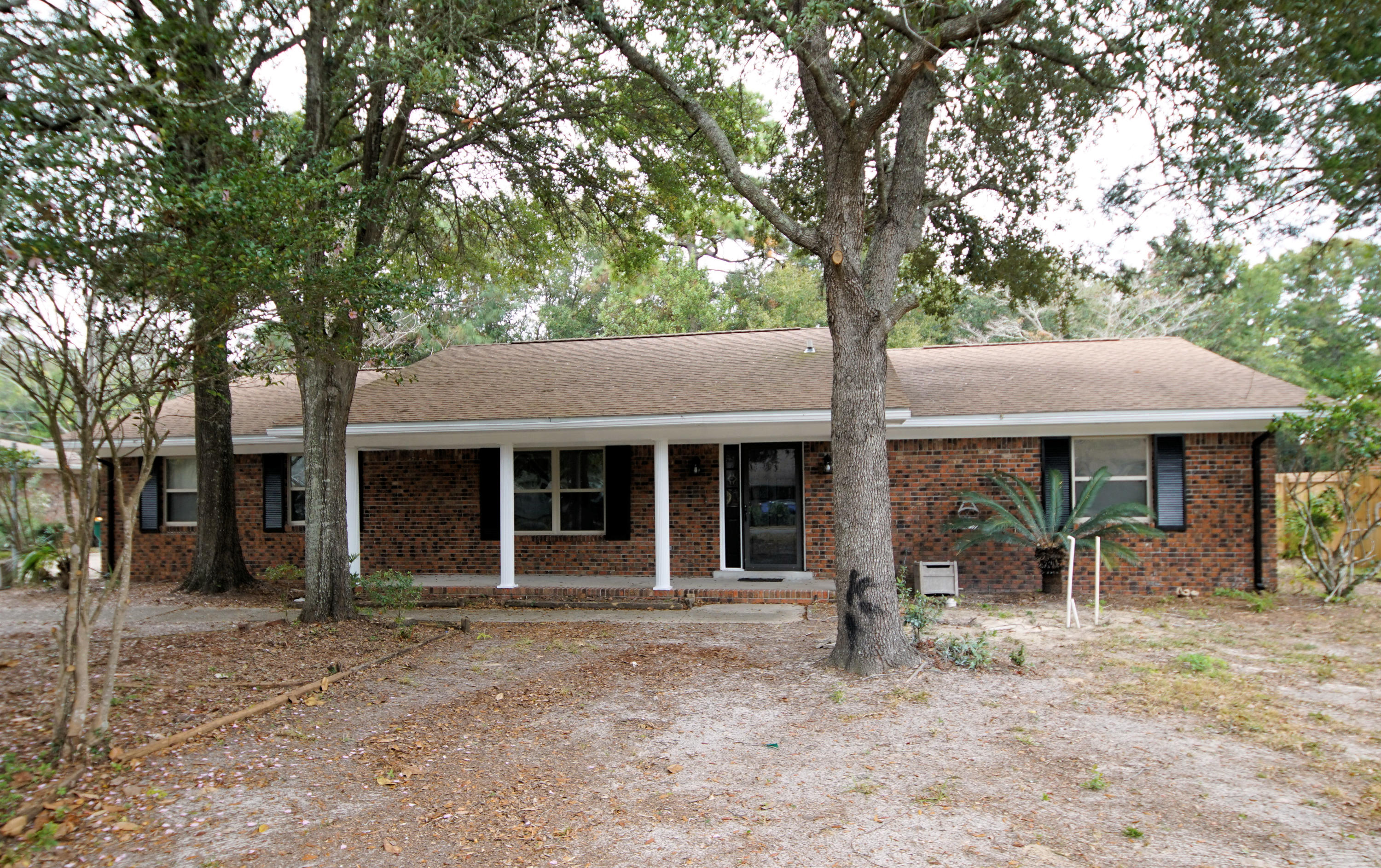 115 Country Club Road Shalimar, FL 32579 - Photo 1 of 25 a front view of a house with yard patio and garden