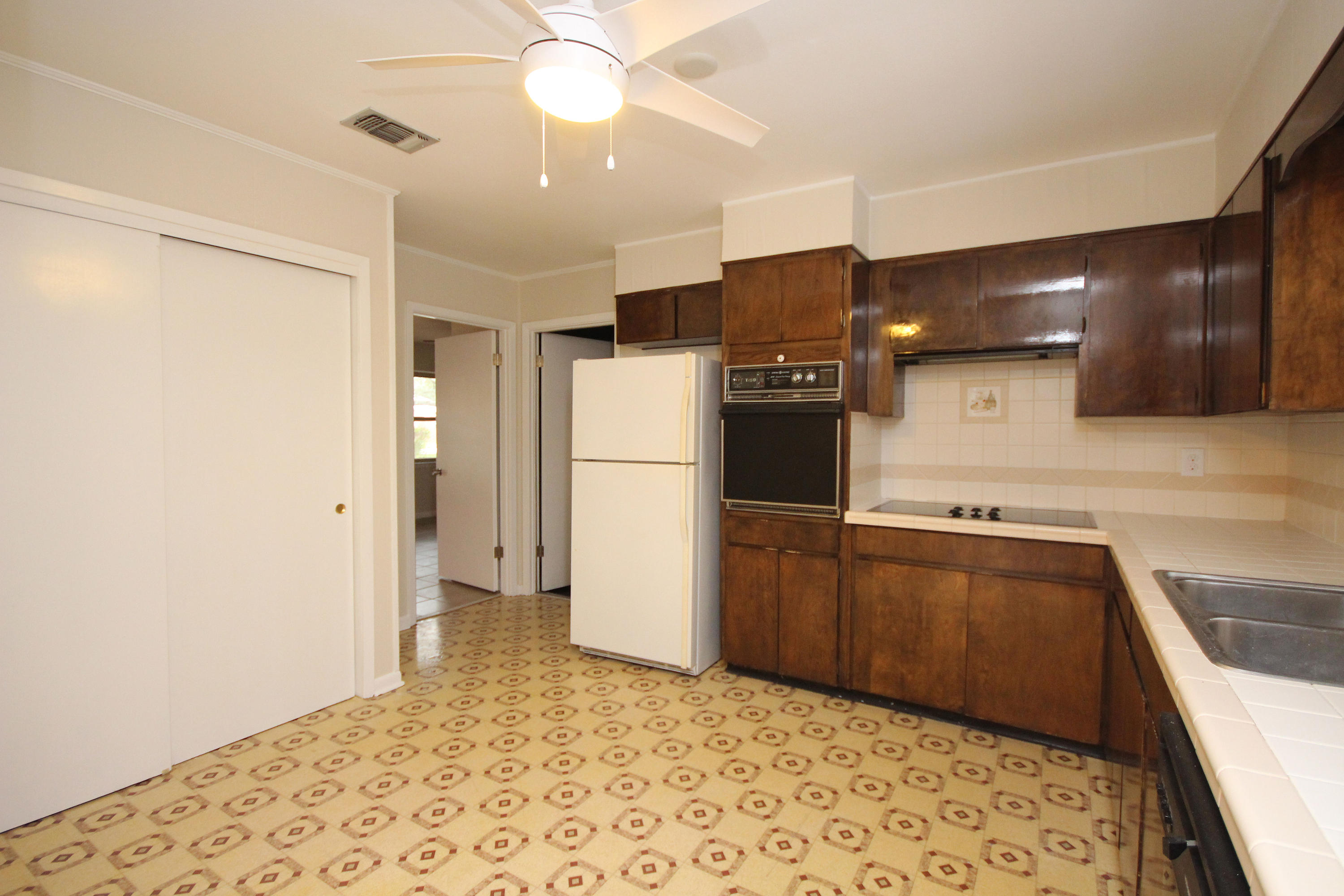 115 Country Club Road Shalimar, FL 32579 - Photo 11 of 25 a kitchen with stainless steel appliances granite countertop a refrigerator and a sink