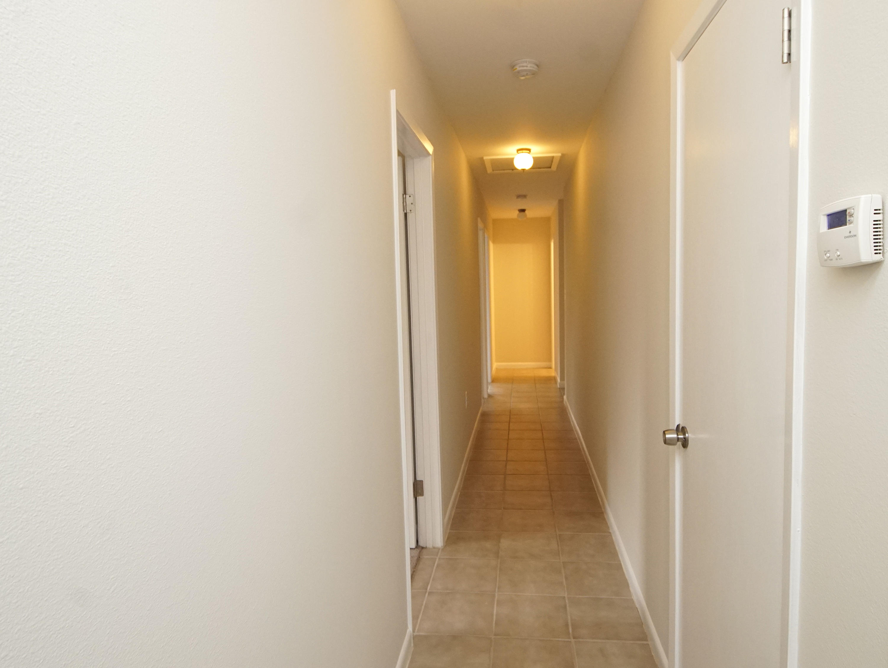 115 Country Club Road Shalimar, FL 32579 - Photo 12 of 25 a view of a hallway with wooden floor