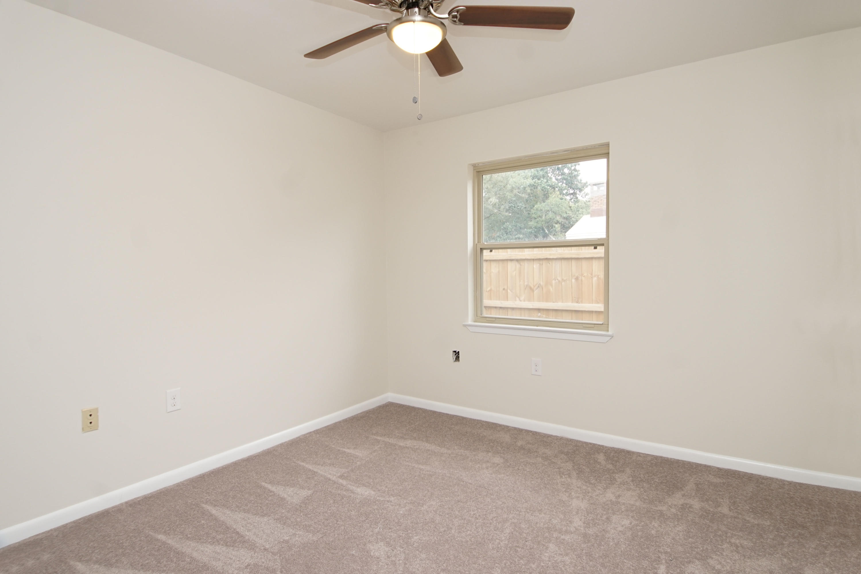 115 Country Club Road Shalimar, FL 32579 - Photo 18 of 25 an empty room with a window and a fan