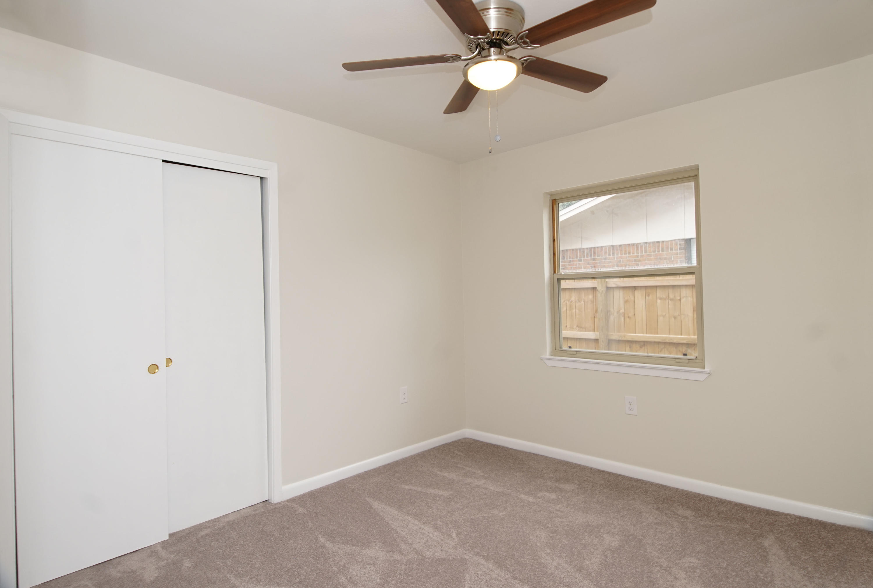 115 Country Club Road Shalimar, FL 32579 - Photo 19 of 25 an empty room with a window and a fan
