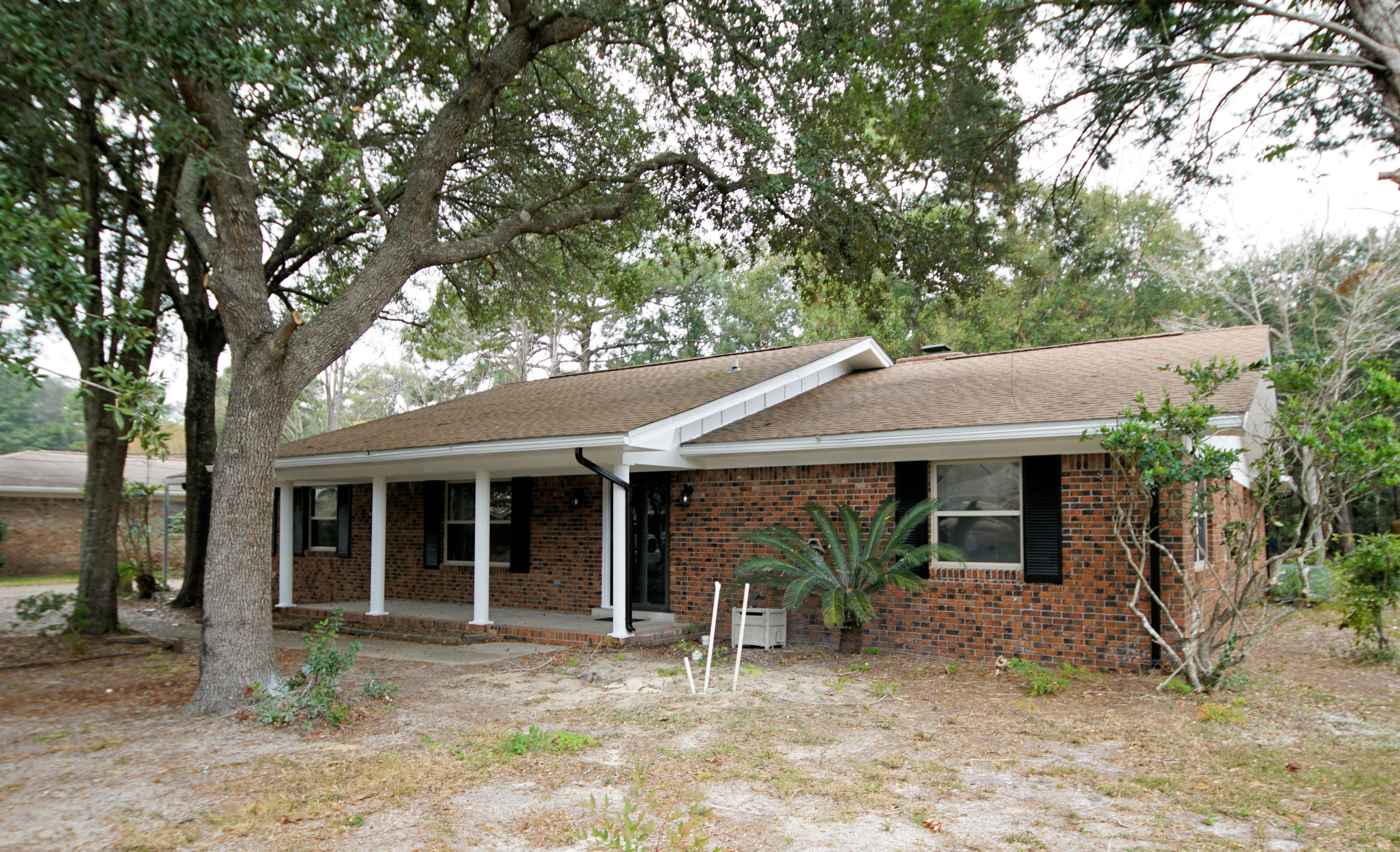115 Country Club Road Shalimar, FL 32579 - Photo 2 of 25 a view of a house with a tree in front of it
