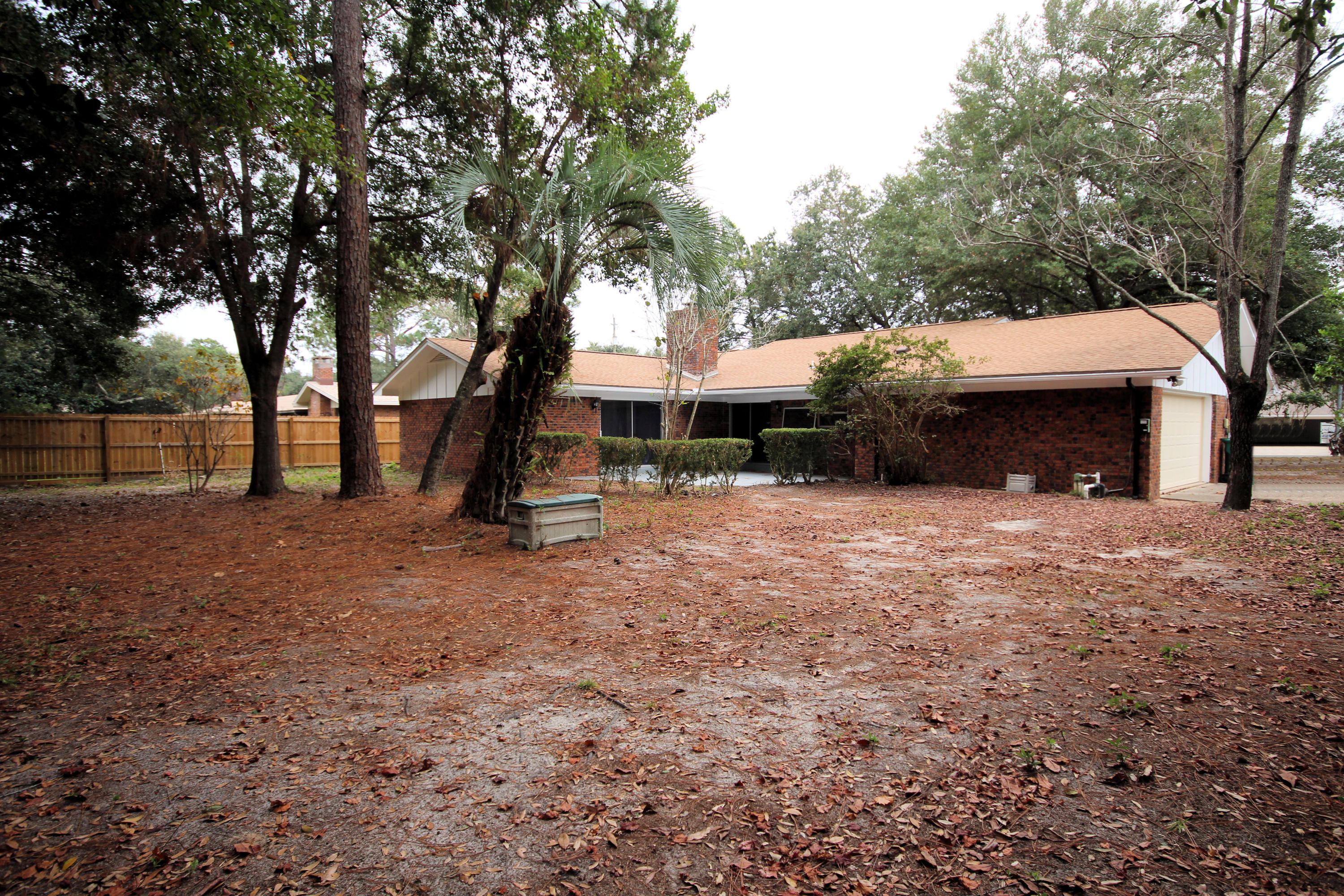 115 Country Club Road Shalimar, FL 32579 - Photo 21 of 25 a view of a house with a yard and tree