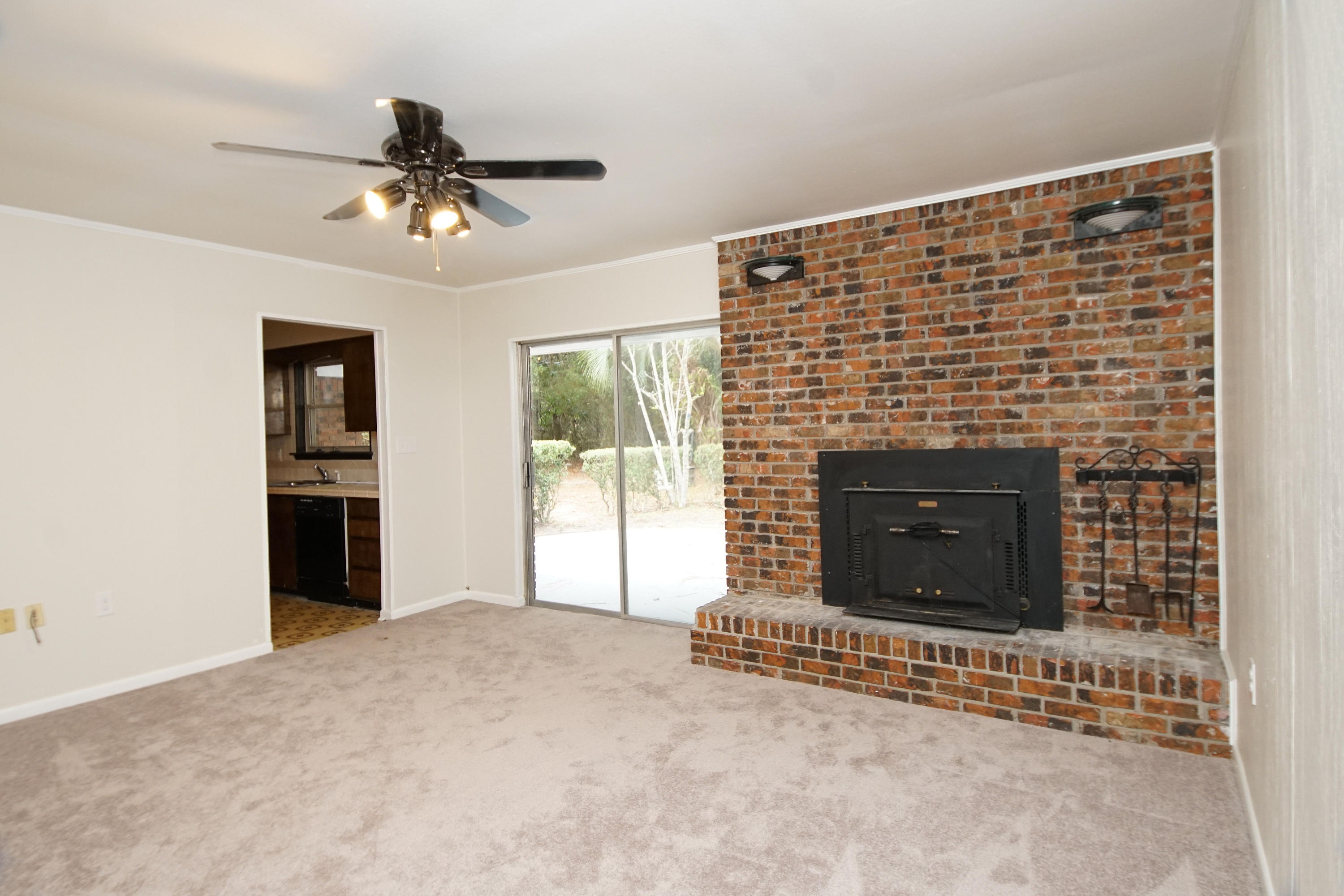 115 Country Club Road Shalimar, FL 32579 - Photo 8 of 25 a view of an empty room with a fireplace and a window