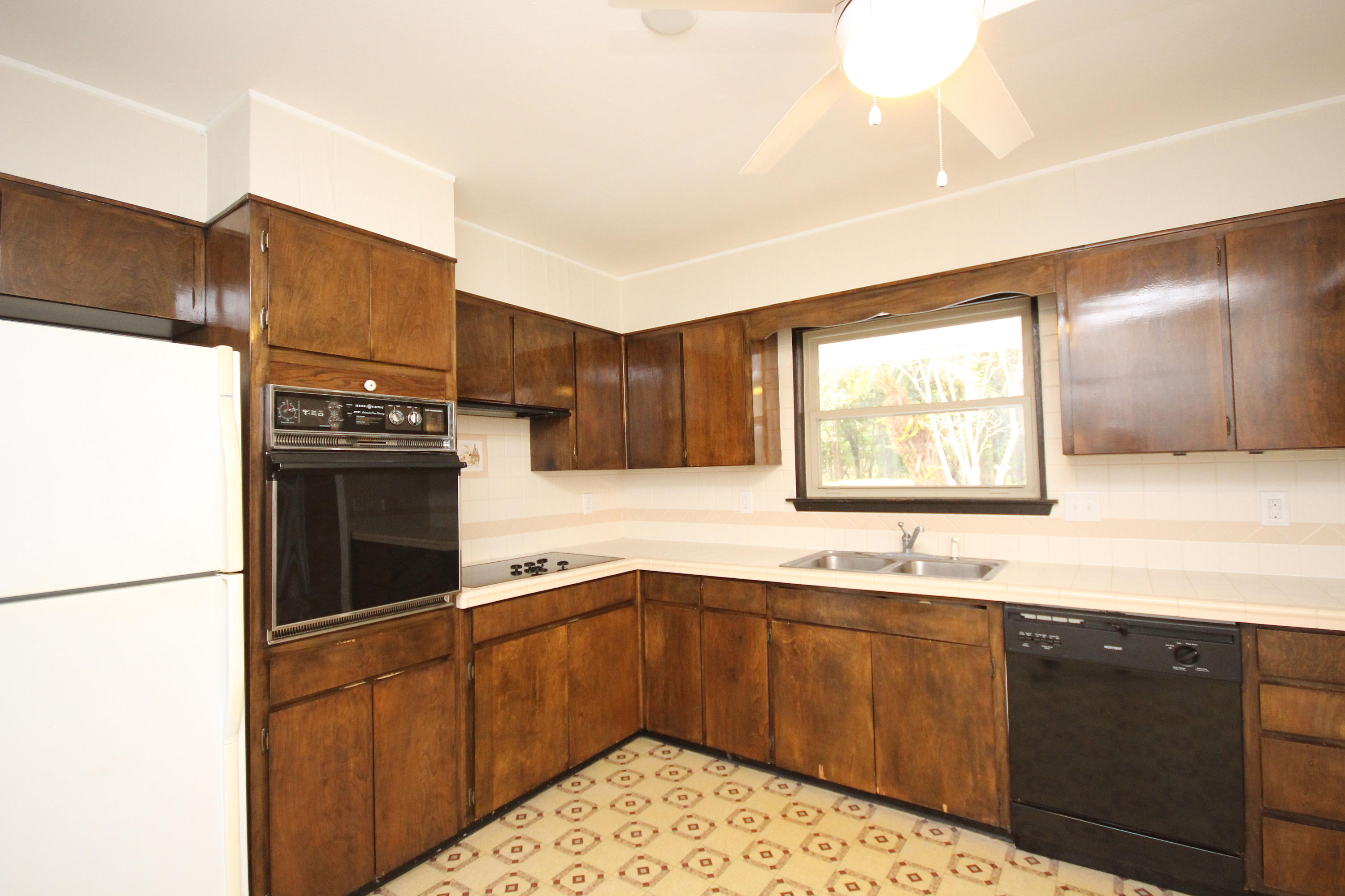 115 Country Club Road Shalimar, FL 32579 - Photo 10 of 25 a kitchen with granite countertop a sink stainless steel appliances and cabinets