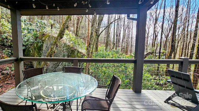 a view of a chairs and table in the balcony
