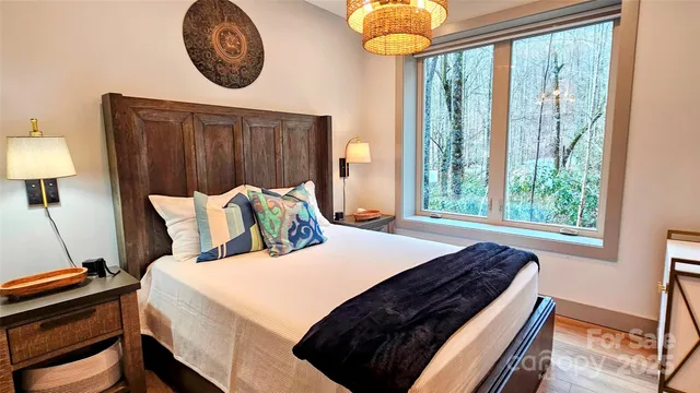 a bed sitting in a bedroom next to a window