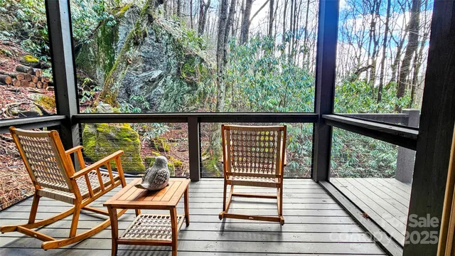a view of a two chairs and table in the balcony