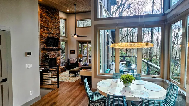 a dining room with furniture and a floor to ceiling window
