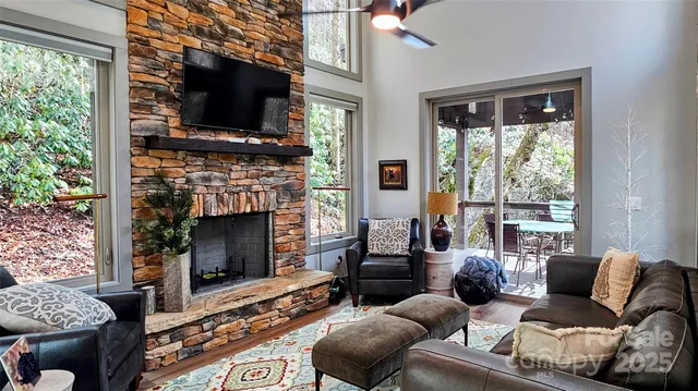 a living room with furniture a flat screen tv and a fireplace