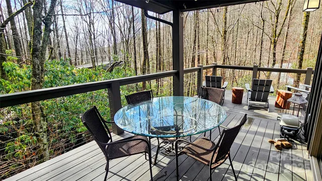 a view of balcony with chairs and wooden fence